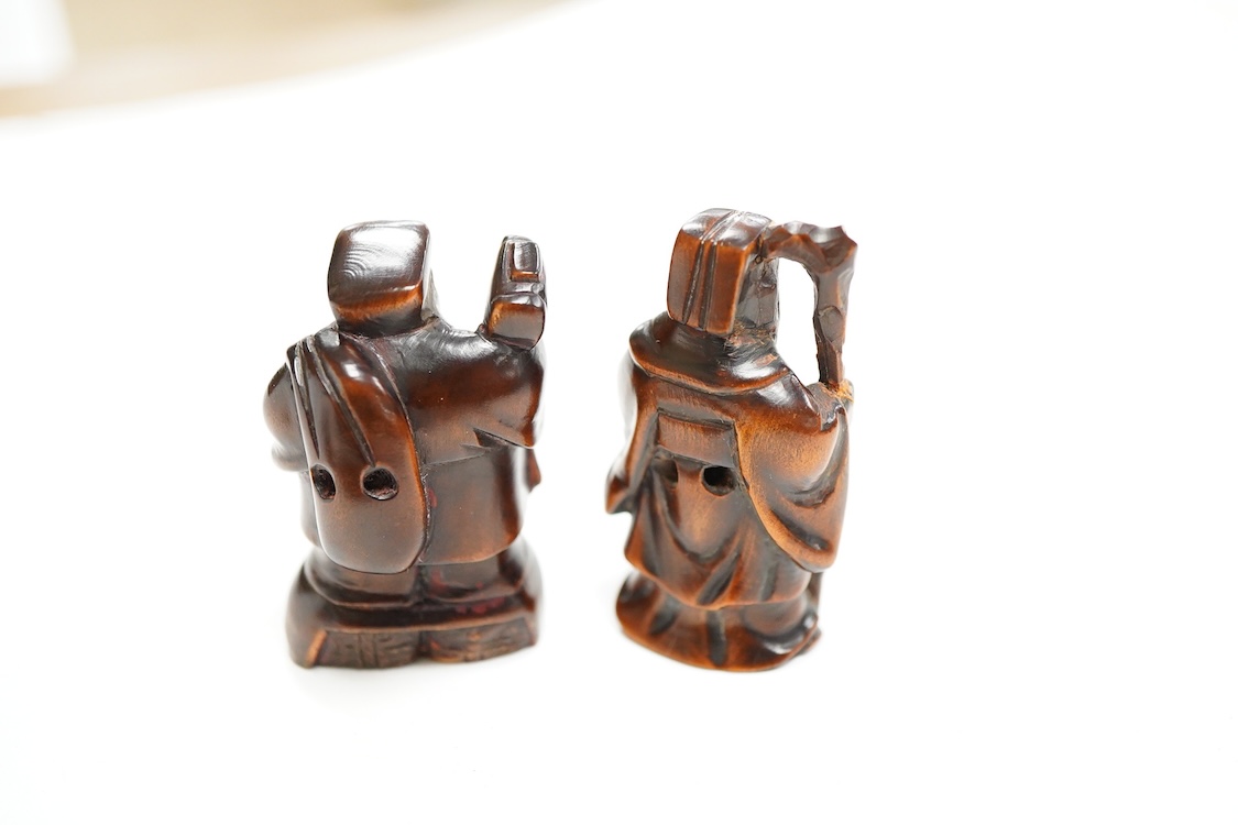 Four Japanese carved wood netsuke to include two elders and a novelty figure seated on a bird, largest 5cm high